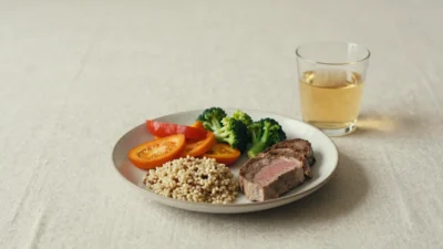 A balanced plate with vegetables, wholegrains, and protein in soft natural light, symbolizing simple, nourishing everyday nutrition.